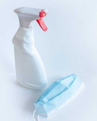 bottle-spray-white-color-with-red-button-liquid-soap-medical-mask-is-table bottle-spray-white-color-with-red-button-liquid-soap-medical-mask-is-table